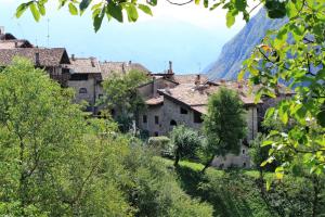 un pueblo al lado de una montaña en La Piazzetta di Canale B&B, en Tenno