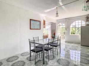 a dining room with a table and chairs at Spacious Apartment in Calodyne with Enclosed Garden in Calodyne