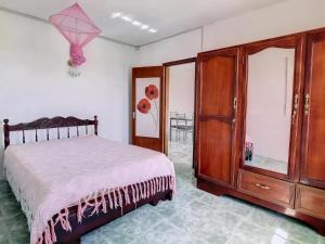 a bedroom with a bed and a wooden dresser at Spacious Apartment in Calodyne with Enclosed Garden in Calodyne +7 photos