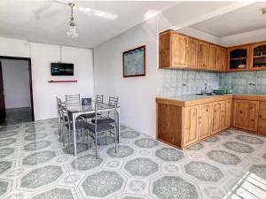a kitchen with a table and chairs in a room at Spacious Apartment in Calodyne with Enclosed Garden in Calodyne