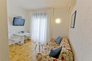 a living room with a couch and a table at Pension Alba in Podstrana