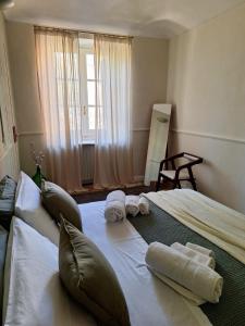 a bedroom with a large bed with towels on it at Casa Salvia in Turin