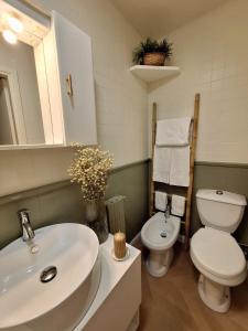a bathroom with a white sink and a toilet at Casa Salvia in Turin