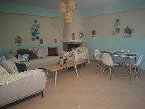 a living room with a couch and a table at Xaido's House near airport port sea in Artemida +33 photos