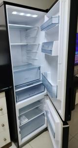 an empty refrigerator with its door open with its door open at La grande Hotel & Residence in Angeles