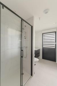 a bathroom with a shower with a glass door at AR SKOL - Magnifique duplex face à la mer in Porspoder +42 photos
