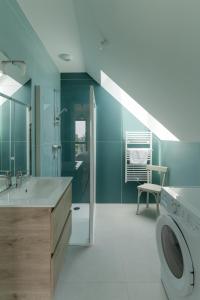 a bathroom with a sink and a washing machine at AR SKOL - Magnifique duplex face à la mer in Porspoder