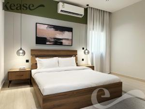 a bedroom with a large bed with a white bedspread at Kease Narjis C-8 Royal Touch AG55 in Riyadh