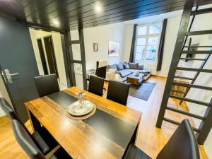 a dining room and living room with a table and chairs at #112 Moderne Altstadt Wohnung im Herzen von Remscheid-Lennep in Remscheid +15 photos