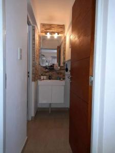 a small kitchen with a sink and a mirror at Casa Victoria in Victoria