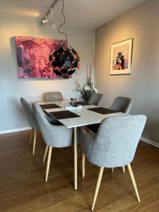 a dining room with a table and chairs at Villa apartment in Trondheim