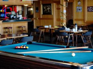 a pool table in a bar with tables and chairs at The Ritz Cafe and Motor Inn in Whitecourt +28 photos