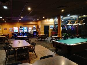 a restaurant with a pool table and tables and chairs at The Ritz Cafe and Motor Inn in Whitecourt