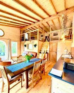 a dining room and kitchen in a tiny house at Domaine de Faye in Sauvigny-les-Bois +70 photos