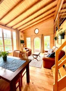 a living room with a table and a couch at Domaine de Faye in Sauvigny-les-Bois