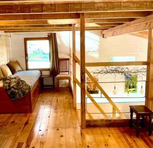 a bedroom with a bunk bed and a staircase at Domaine de Faye in Sauvigny-les-Bois