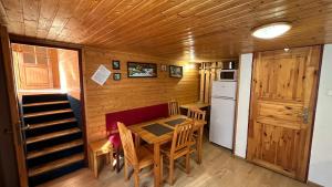 a kitchen and dining room with a table and chairs at Chalupa u Porubäna in Liptovský Ondrej