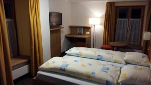 Postel nebo postele na pokoji v ubytování Hotel Stätzerhorn