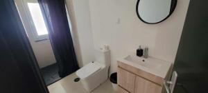 a bathroom with a toilet and a sink and a mirror at Casa do Alto in Nadadouro +21 photos