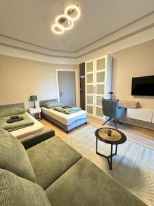 a living room with a couch and a bed at Schulz Apartments Menden in Sankt Augustin