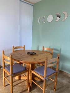 a wooden table with two chairs and a wooden table and a table at Le beau séjour in Grosbreuil +4 photos