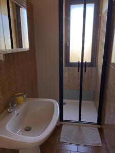 a bathroom with a shower and a sink and a tub at Le beau séjour in Grosbreuil