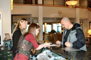 a group of people standing at a counter in a store at Oceanfront Lodge in Crescent City +37 photos