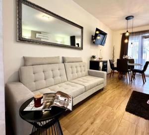 a living room with a white couch and a table at Holiday&Suite Klanac in Vir