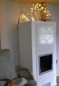 a living room with a fireplace and a chandelier at Villa in Kalajoki