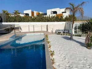a swimming pool in front of a building at Paraiso House in Callao Salvaje