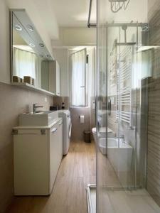 a bathroom with two sinks and a glass shower at Alma House in Finale Ligure +7 photos