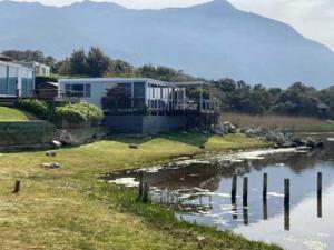 a house on the shore of a body of water at Moonshine in Hermanus
