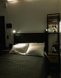 a bedroom with a large bed with white pillows at Studio Mayer in Patra