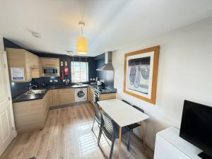 a small kitchen with a table and a dining room at Casa Crusoe in Reighton