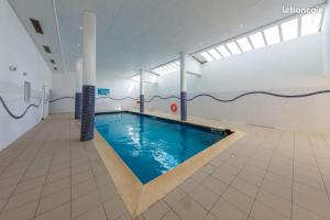 a large swimming pool in a building with a swimming pool at FOUX D ALLOS Piscine 6 personnes in Allos