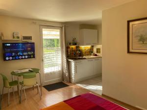 a kitchen with a table and a small table and chairs at Lou Souleu in Sisteron