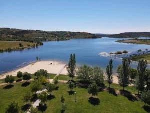 an aerial view of a lake with trees and a beach at Casa Eva e Eduardo in Macedo de Cavaleiros