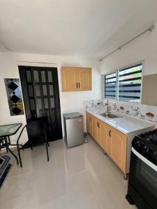 a kitchen with a sink and a stove at Escondite en Nagua in Nagua +9 photos