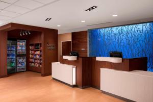 a waiting room with a large blue screen in a store at Fairfield Inn & Suites by Marriott Memphis Marion, AR in Marion