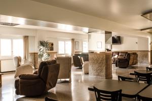 La Trobada Hotel Sport في ريبول: غرفة معيشة مع كراسي وطاولة وأريكة
