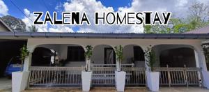 a zea homesay sign on the side of a building at Zalena's Homestay in Kuala Kerai +7 photos