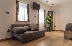 a living room with a couch and a flat screen tv at PosestvoRavbar in Dutovlje