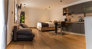 a bedroom with a bed and a table and a kitchen at PosestvoRavbar in Dutovlje
