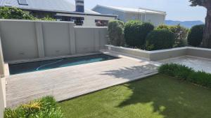 a backyard with a swimming pool and a house at Sea'scapes in Cape Town