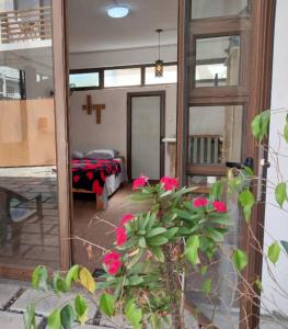 a view of a room with a mirror and flowers at Love Cosy Studios in Flic-en-Flac