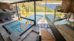 a pool in a house with a view of the mountains at Ansitz Velseck-Residence Hotel in Tires