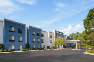 an exterior view of a building with a parking lot at SpringHill Suites Pinehurst Southern Pines in Pinehurst