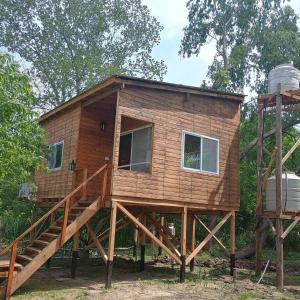 a tiny house with a staircase and a water tank at Mi Refugio Cabaña in Tigre