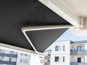 awning on a building with buildings in the background at Fashion Stay - Valentino Home - By OpenHouse in Giroc