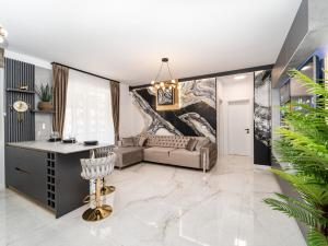 a living room with a couch and a table at Fashion Stay - Valentino Home - By OpenHouse in Giroc